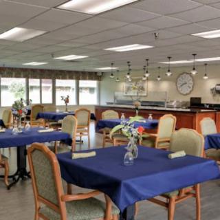 A well-decorated dining area with tables covered in blue tablecloths.