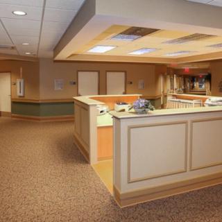 A hospital reception area with a desk and spacious layout.