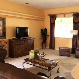 A cozy living room featuring classic furniture and warm decor.