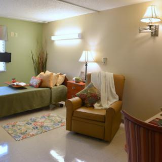 A cozy living room featuring a comfortable sofa, an armchair, and warm decorative elements.