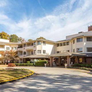 A sunny view of a modern residential building with well-kept landscaping.