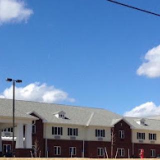 A modern residential building under a clear blue sky.