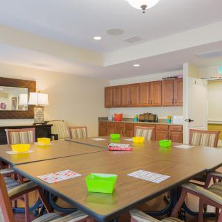 A well-lit meeting room equipped with a large table and chairs, ready for a conference or group discussion.