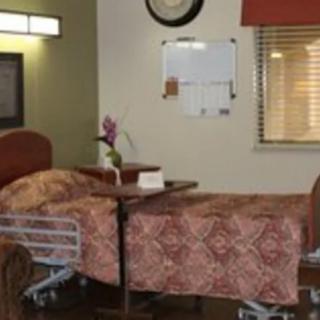 A hospital room with a bed and medical equipment.