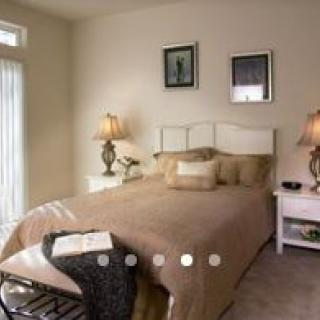 A cozy, well-decorated bedroom with soft lighting and elegant furniture.