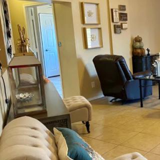 A cozy living room setting featuring comfortable seating and decorative elements.