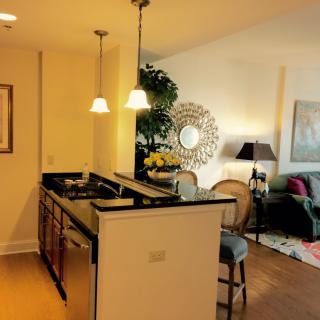 A modern kitchen and living room with stylish lighting and decor.