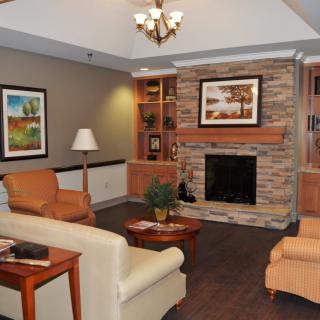 A cozy living room with a fireplace, comfortable seating, and tasteful decor.