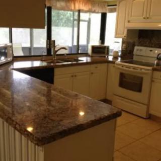 A modern kitchen with a spacious countertop and various appliances.