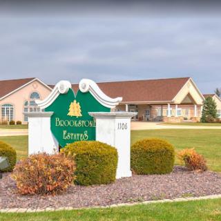 Entrance sign for a residential community surrounded by landscaped gardens.