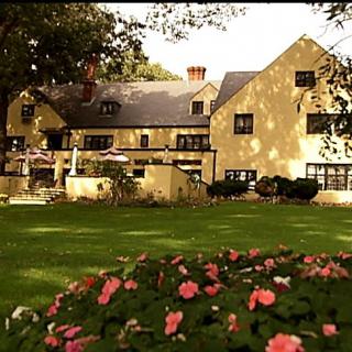 A charming house with a well-maintained garden featuring colorful flowers.