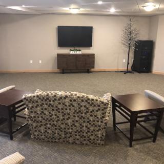 A cozy living room setup with a TV, couch, and modern furniture.