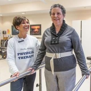 A physical therapist assisting a patient during a rehabilitation session.