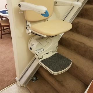 A stairlift installed on a residential staircase for accessibility.