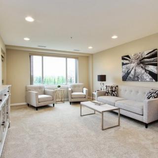 A modern living room with neutral tones and elegant decor.