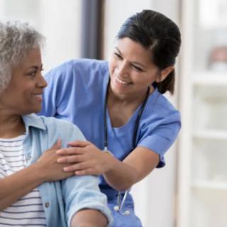 A nurse provides care and support to a patient.