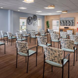 A well-arranged meeting room with patterned chairs and decorative elements on the walls.