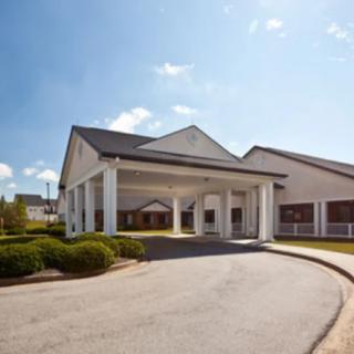A front view of a building with a prominent entrance and clear sky.