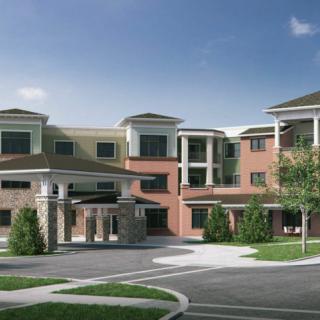 A modern apartment complex with a multi-story design and landscaped surroundings.