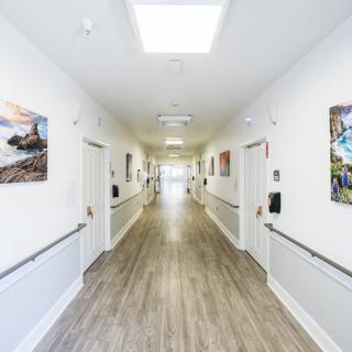 A modern and clean hospital hallway with artwork on the walls.
