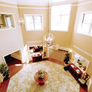 A modern, spacious living room with large windows and elegant decor.