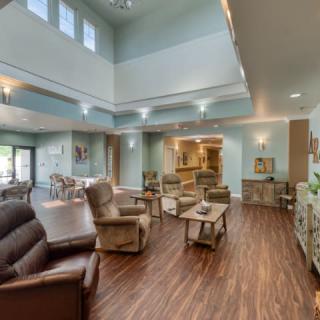 Spacious living room with comfortable armchairs and wood flooring.