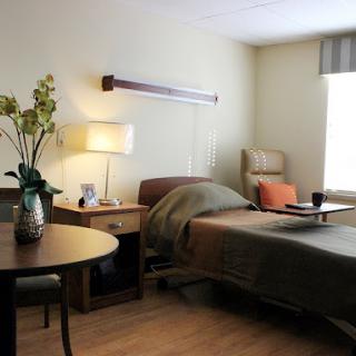A serene hospital room with a comfortable bed and a cozy atmosphere.