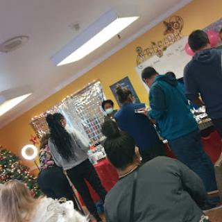 A festive gathering where people are enjoying a Christmas celebration.