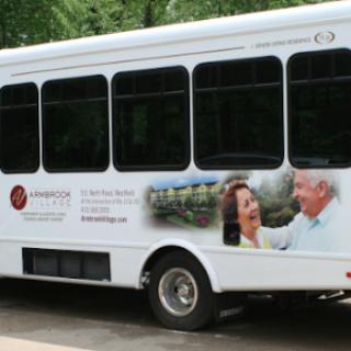 A bus featuring an advertisement aimed at senior citizens, highlighting community services.