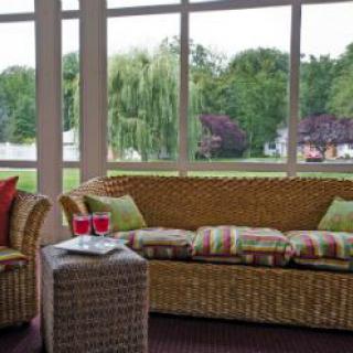 A cozy patio with wicker furniture and a scenic outdoor view.