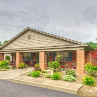 A suburban house with well-maintained landscaping and a front porch.