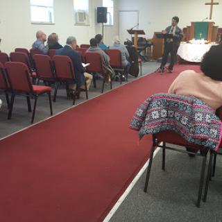 A speaker addressing an audience in a church setting.