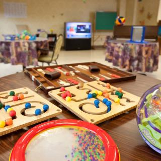 A children's playroom with various educational toys and puzzles on display.