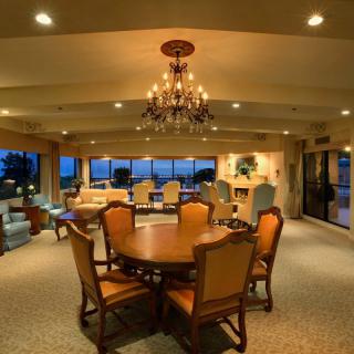 Luxurious dining room with elegant chandelier and stylish furniture.