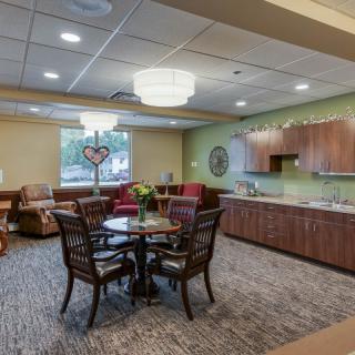 A modern lounge area with comfortable seating and a kitchenette.