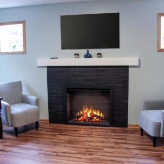 A cozy living room with a modern fireplace and comfortable seating.