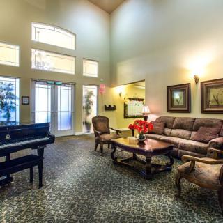 Elegant lobby with a grand piano and comfortable seating arrangement.