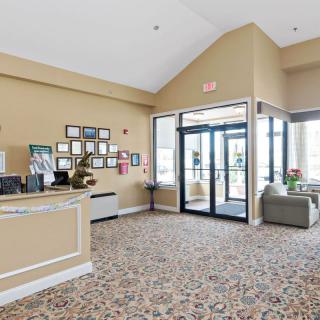 A hotel lobby with a front desk and seating area near the entrance.