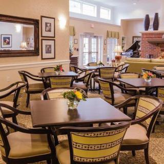 A cozy dining area with elegant furniture and floral decorations.
