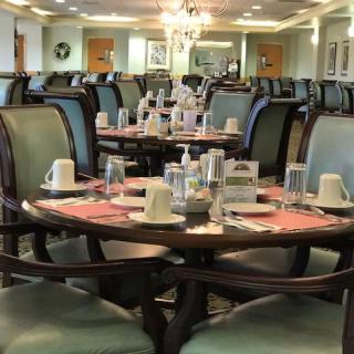 A well-arranged dining area with multiple tables set for guests.