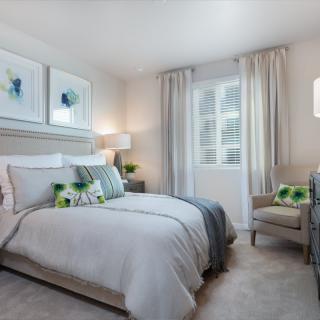 A modern and cozy bedroom with elegant decor and comfortable bedding.