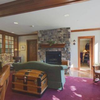 A cozy living room featuring a stone fireplace and comfortable seating.
