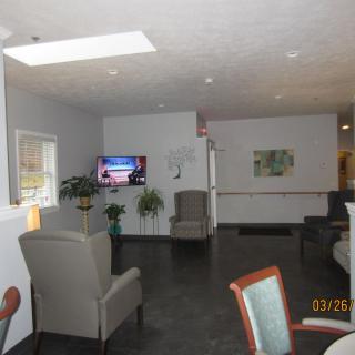 A modern lounge area with comfortable seating and a television.