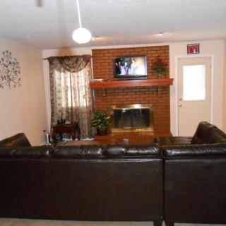 Cozy living room with a brick fireplace and comfortable seating.