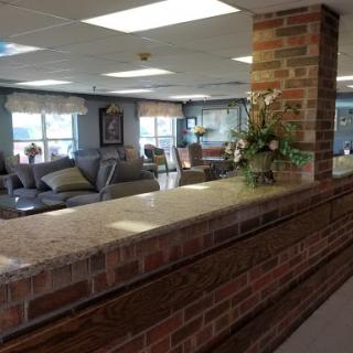 An inviting reception area featuring a spacious lobby with comfortable seating and decorative elements.