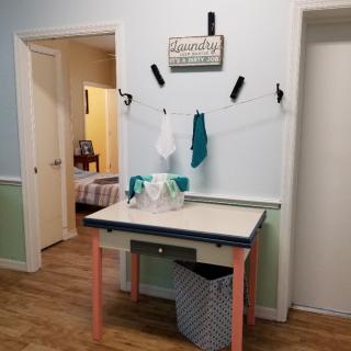 A cozy sewing workspace with a sewing machine and craft supplies.