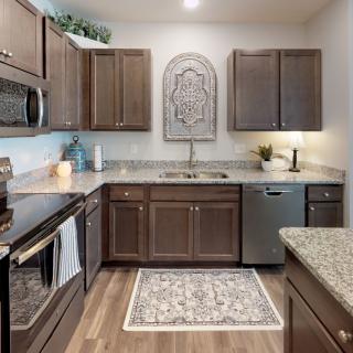 A modern kitchen with wooden cabinets and stainless steel appliances.