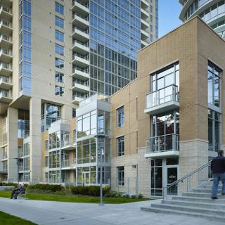 A modern urban residential complex with high-rise buildings and glass windows.