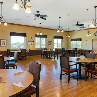 A spacious dining area designed for communal gatherings, featuring tables and chairs arranged for dining.