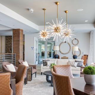 A modern and stylish living room featuring contemporary chandeliers and elegant furniture.